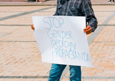 Man,Protesting,With,A,Paper,Banner,",Stop,Gender,Ideology