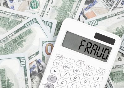 Fraud,Text,On,A,Calculator,With,Us,Dollar,Money,On