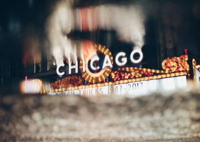 Iconic,Chicago,Theater,Sign,Reflected,In,A,Rainy,Street