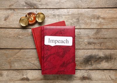 Law,Books,With,Word,Impeach,And,Scales,Of,Justice,On
