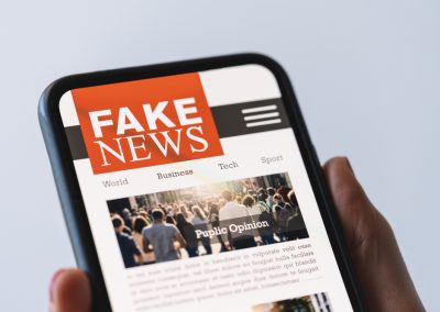 Online,Fake,News,On,A,Mobile,Phone.,Close,Up,Of