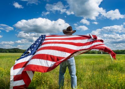 Man,Wearing,Cowboy,Hat,Waving,American,Flag,Standing,In,Grass