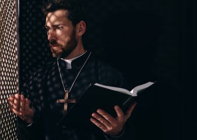 Catholic,Priest,In,Cassock,Holding,Bible,And,Talking,To,Parishioner