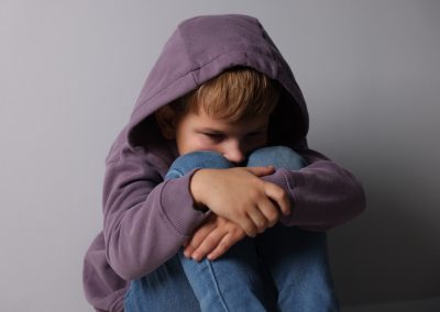 Upset,Little,Boy,Near,Light,Grey,Wall,Indoors