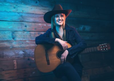 Cowgirl,Country,Singer,With,Acoustic,Guitar.,Wearing,Blue,Jeans,And