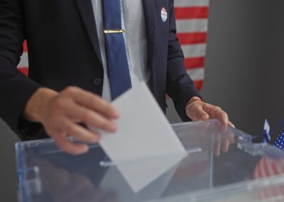 Donald Trump Has Won This Exact Fight Five Times and Now Blue States Are in Line for More Hispanic,Man,Voting,Indoors,With,American,Flag,In,Background,,Imbuing